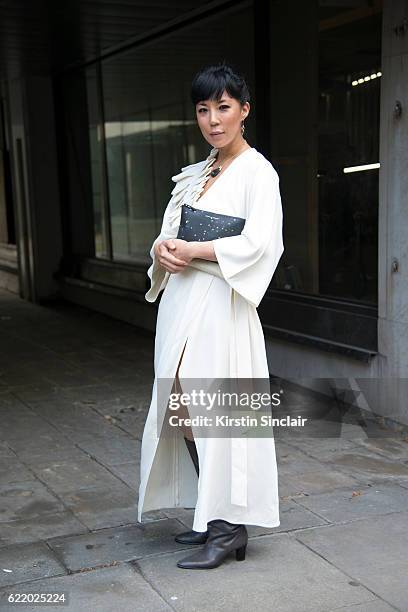 Fashion buyer and owner of the Satine Boutique Jeannie Lee wears an Osman Yousefzada dress, Comme des Garcons bag and Balenciaga boots day 4 of...