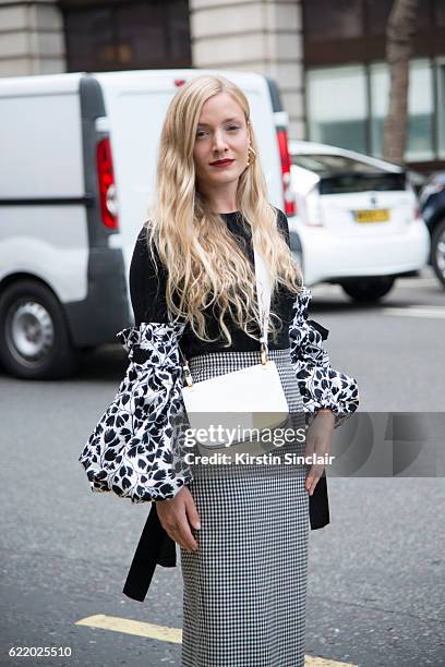 Fashion Stylist Kate Foley Osterweis wears a Miu Miu skirt, Prada bag day 4 of London Womens Fashion Week Spring/Summer 2016, on September 19, 2016...