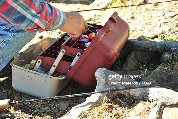 fisherman making preparation for fishing - fishing tackle box stockfoto's en -beelden