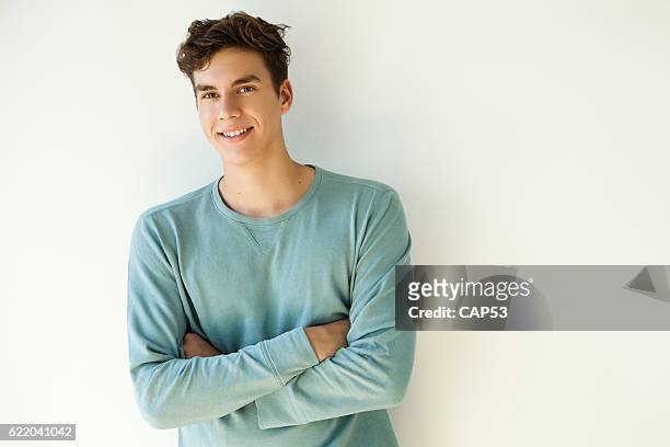 portrait of a young man smiling - young men stock pictures, royalty-free photos & images