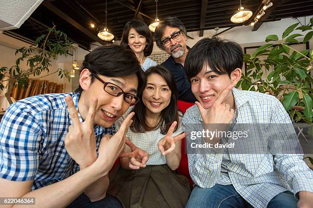 happy japanese family with peace finger signs - japanese culture on show at hyper japan stock pictures, royalty-free photos & images