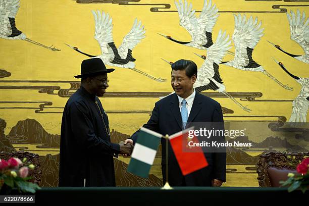 Beijing, China - File photo shows Nigerian President Goodluck Jonathan shaking hands with Chinese President Xi Jinping in the Great Hall of the...