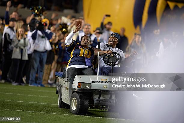 Former California running back Marshawn Lynch with his mother Delisa driving a golf cart on field and leading California players onto field before...