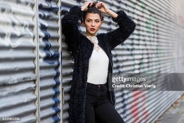 Fata Hasanovic wearing a black fluffy coat from sassy classy, a white laced top on November 9, 2016 in Berlin, Germany.