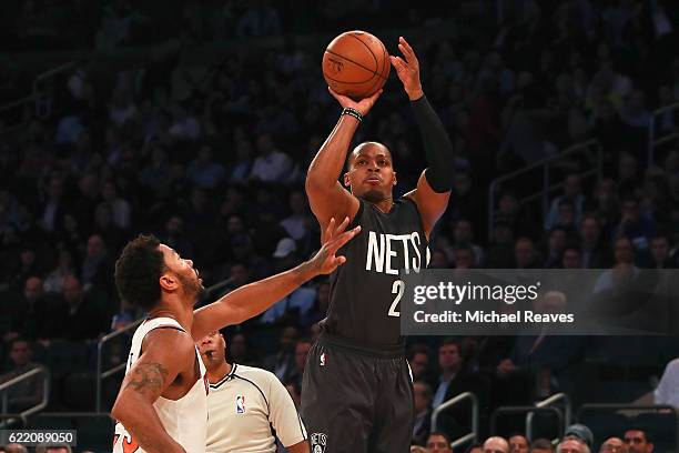 Randy Foye of the Brooklyn Nets shoots a jumper over Derrick Rose of the New York Knicks during the first half at Madison Square Garden on November...