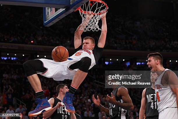 Kristaps Porzingis of the New York Knicks dunks against the Brooklyn Nets during the second half at Madison Square Garden on November 9, 2016 in New...