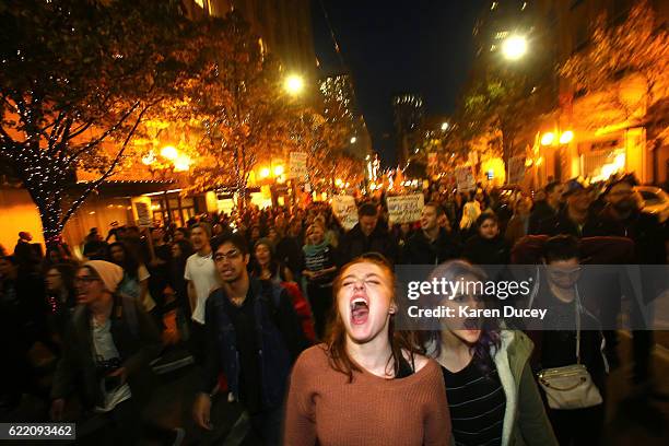 Sasha Savenko and Sydney Kane , both students at the University of Washington, join thousands of protesters march down 2nd Avenue on November 9, 2016...