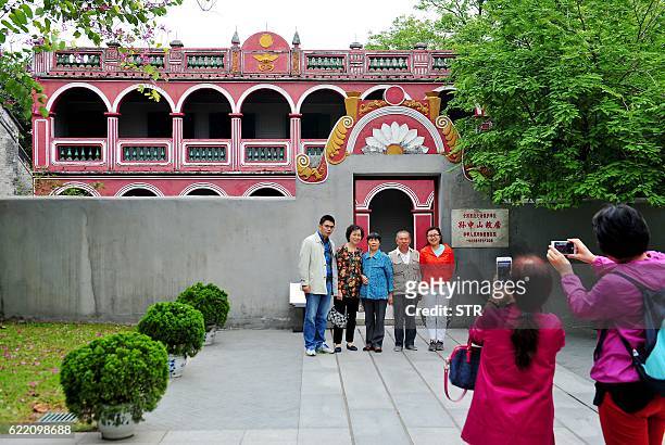 This picture taken on November 9, 2016 shows visitors posing for photos in front of the former residence of republican revolutionary Sun Yat-sen, now...
