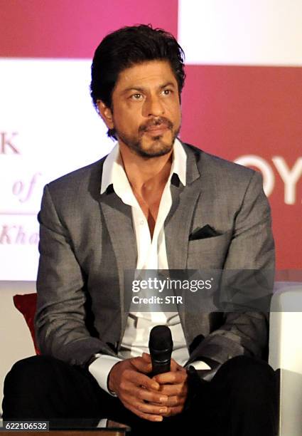 Indian Bollywood actor Shah Rukh Khan poses during the launch of 'SRK 25 Years Of A Life' by Samar Khan, in Mumbai late November 9, 2016.