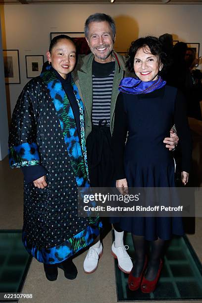 Jean-Paul Goude standing between his wife Karen Park Goude and Monique Lang attend the Carla Sozzani : Photo Exhibition at Azzedine Alaia Gallery on...