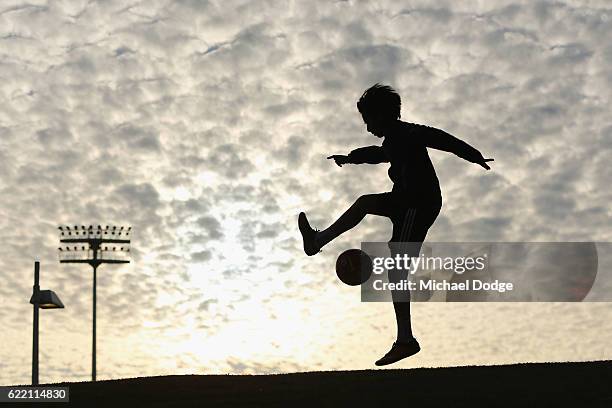 City fan plays with a ball outside the stadium before the round six A-League match between Melbourne City FC and Newcastle Jets at AAMI Park on...