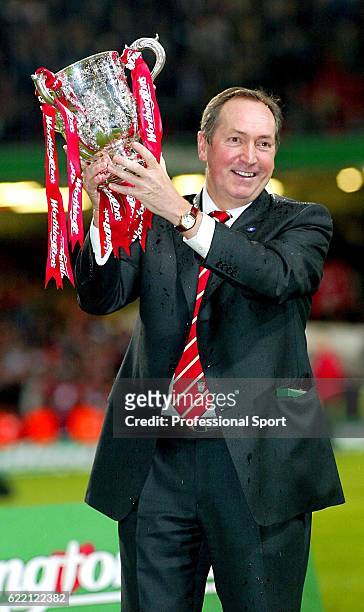 Liverpool manager Gerard Houllier poses with the trophy after the Worthington Cup Final between Liverpool and Manchester United held on March 2, 2003...