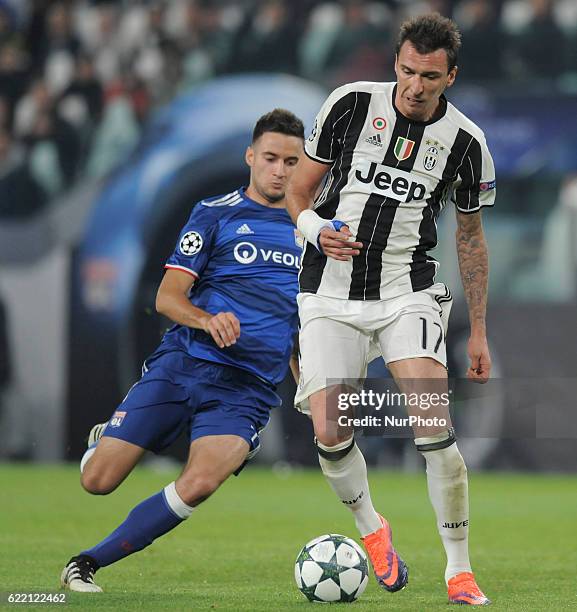 Mario Mandzukic of Juventus goes up with Emanuel Mammana of Olympique Lyonnais during the UEFA Champions League Group H match between Juventus and...