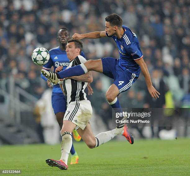 Mario Mandzukic of Juventus goes up with Emanuel Mammana of Olympique Lyonnais during the UEFA Champions League Group H match between Juventus and...