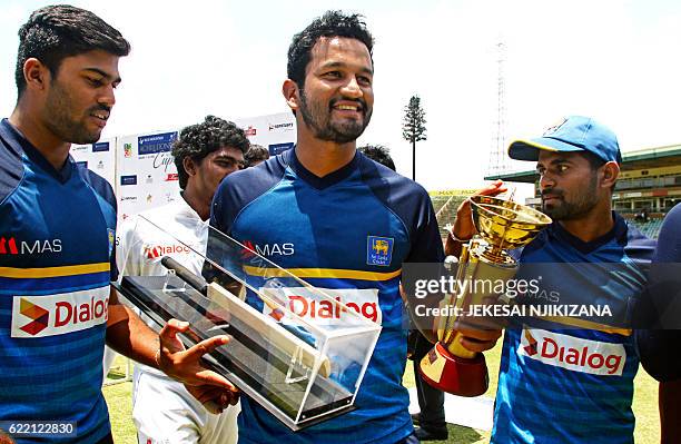 Man of the series Dimuth Karunaratne poses with his award during the fifth day of the second test match between Sri Lanka and hosts Zimbabwe at the...