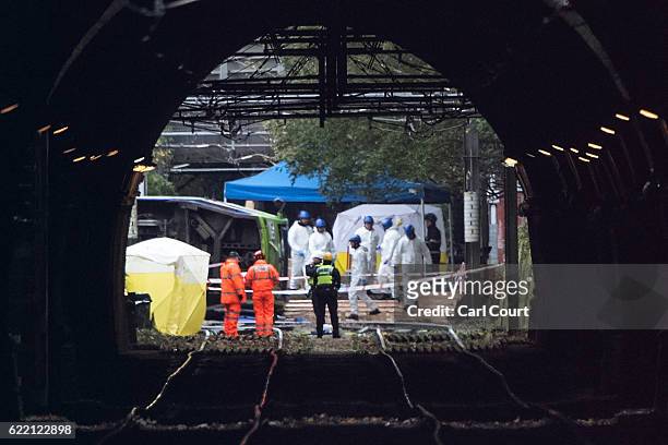 Emergency workers continue to work at the scene of a tram crash on November 10, 2016 in Croydon, England. Seven people were killed and more than 50...