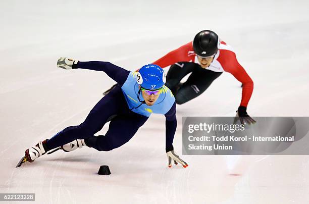 Denis Nikisha of Kazakhstan leads William Preudhomme of Canada in the men's 500 meter quarter final during the ISU World Cup Short Track Speed...