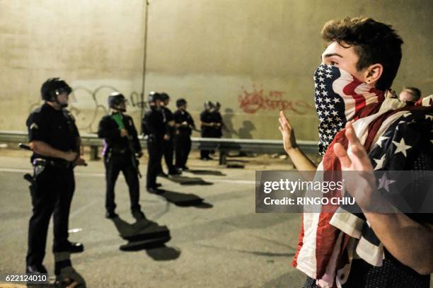 Protester confronts police as protesters shut down the 101 Freeway, a major thoroughfare in the city, following a rally to protest a day after...