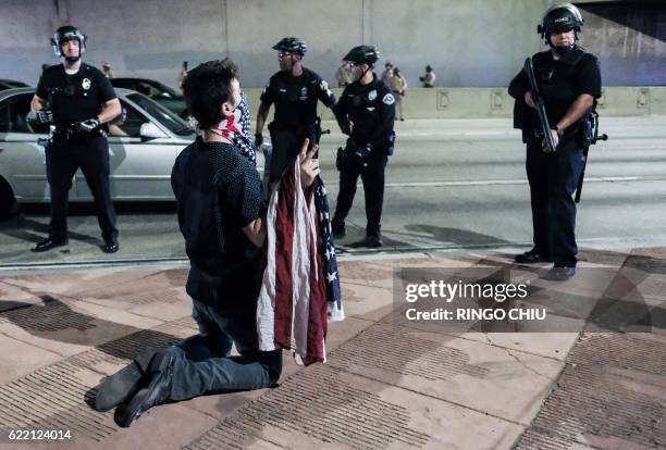 Protester confronts police as protesters shut down the 101 Freeway, a major thoroughfare in the city, following a rally to protest a day after...