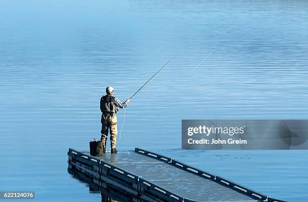 Man flyfishing from a floating dock.