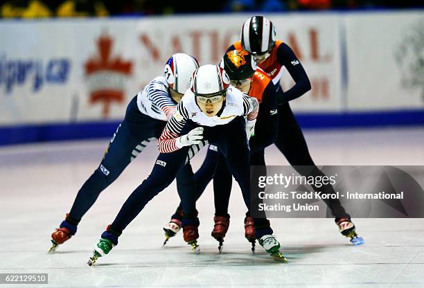 Suk Hee Shim of Korea gets a push from teammate Do Hee Noh while in front of the Netherlands in the women's 3000 meter relay final during the ISU...