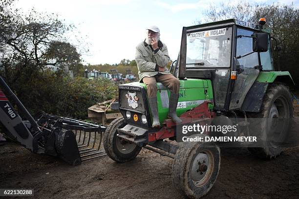 French farmer member of the "Copain 44" , a collective opposed to the controversial Notre-Dame-des-Landes airport project, sits on his tractor as...