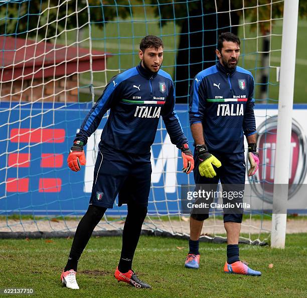 Gianluigi Donnarumma and Gianluigi Buffon chat during the training session at the club's training ground at Coverciano on November 10, 2016 in...