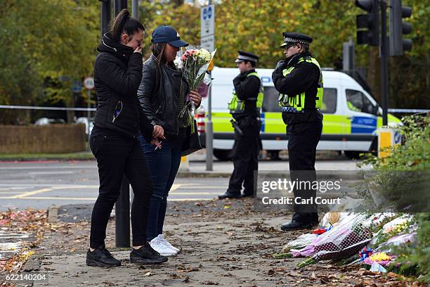 Women lay flowers near the scene of a tram crash, on November 10, 2016 in Croydon, England. Seven people were killed and more than 50 injured after...