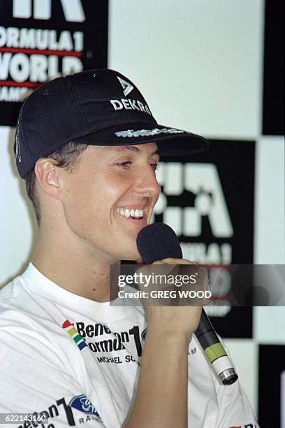 German formula one driver Michael Schumacher smiles while speaking to journalists after his crash in the first qualifying session of the Australian...