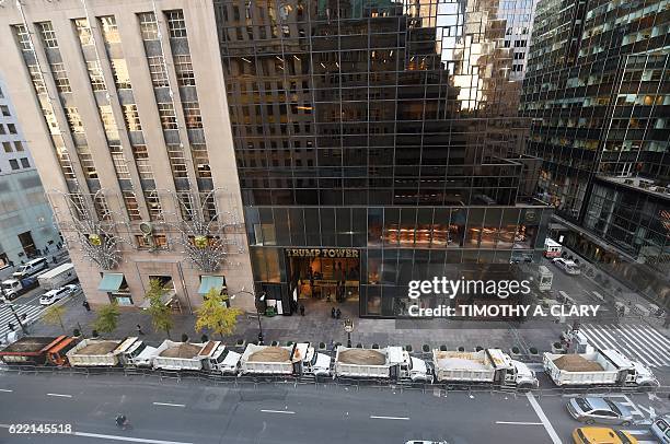 Protective barrier of Sanitation Department trucks are parked in front of Trump Tower on 5th Avenue to provide security to US President-elect Donald...