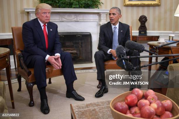 President Barack Obama meets with President-elect Donald Trump to update him on transition planning in the Oval Office at the White House on November...