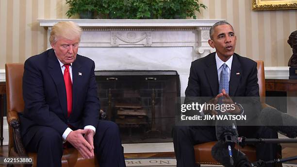 President Barack Obama meets with President-elect Donald Trump in the Oval Office at the White House on November 10, 2016 in Washington, DC. / AFP /...