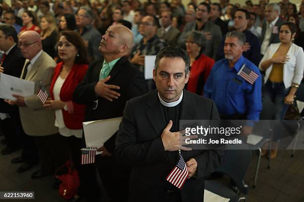 Rafael Garcia, originally from Cuba, becomes an American citizen during a ceremony at the U.S. Citizenship and Immigration Service's Kendall office...