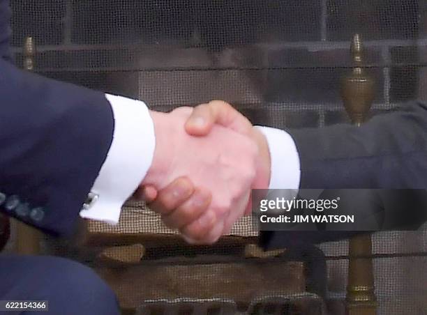 President Barack Obama shakes hands with Republican President-elect Donald Trump during a meeting on transition planning in the Oval Office at the...