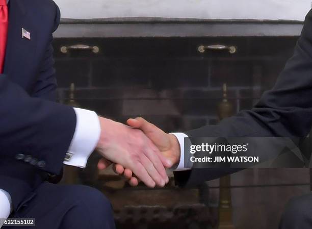 President Barack Obama shakes hands with Republican President-elect Donald Trump during a meeting on transition planning in the Oval Office at the...