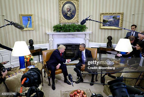 President Barack Obama, right, shakes hands with U.S. President-elect Donald Trump during a news conference in the Oval Office of the White House in...