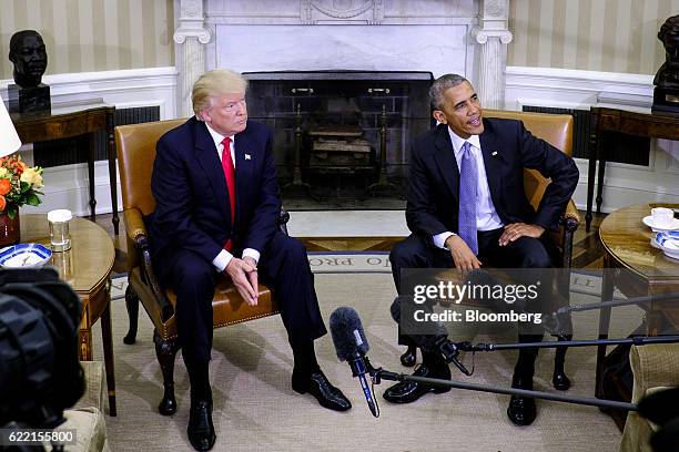President Barack Obama, right, speaks as U.S. President-elect Donald Trump listens during a news conference in the Oval Office of the White House in...