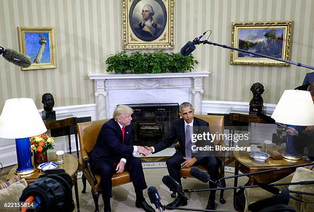 President Barack Obama, right, shakes hands with U.S. President-elect Donald Trump during a news conference in the Oval Office of the White House in...