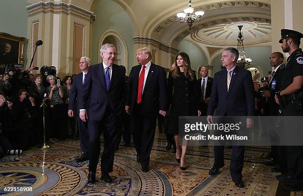 Senate Majority Leader Mitch McConnell , walks with President-elect Donald Trump, his wife Melania Trump, and Vice President-elect Mike Pence , at...