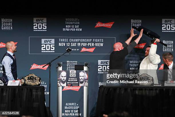 President Dana White stops Conor McGregor from throwing a chair at Eddie Alvarez during the UFC 205 press conference at The Theater at Madison Square...