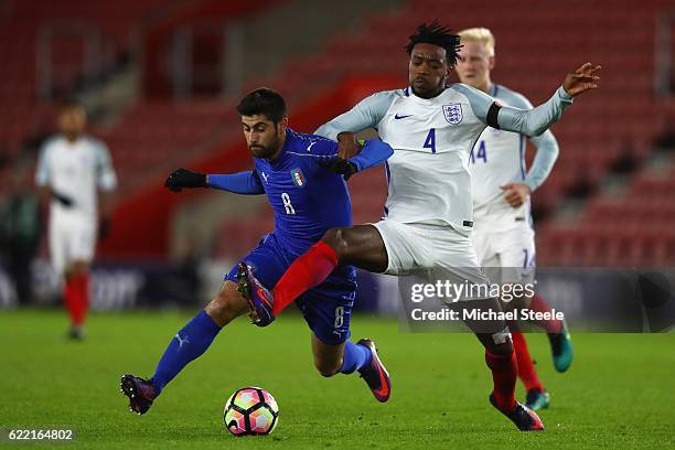 Nathaniel Chalobah of England challenges Marco Benassi of Italy closes in during the FIFA 2018 World Cup Qualifier between England and Italy at St...