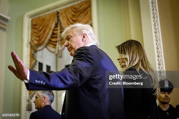 President-elect Donald Trump, left, and First Lady-elect Melania Trump exit after a meeting with Senate Majority Leader Mitch McConnell, a Republican...