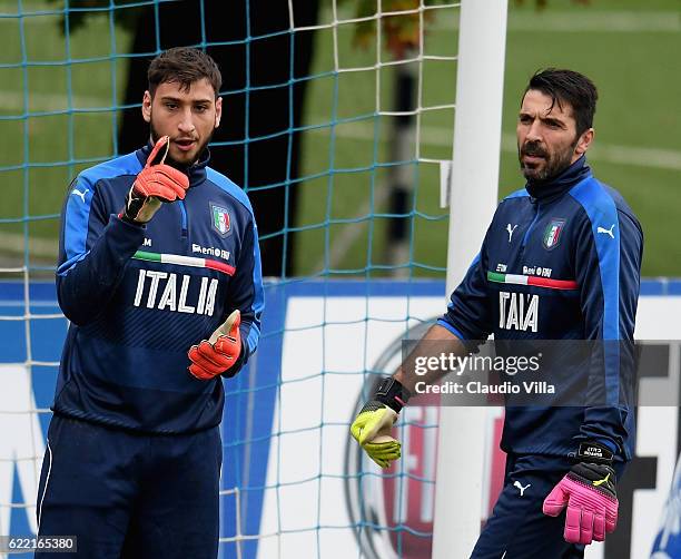 Gianluigi Donnarumma and Gianluigi Buffon chat during the training session at the club's training ground at Coverciano on November 10, 2016 in...