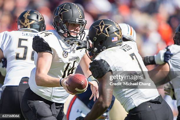 Quarterback Kyle Shurmur of the Vanderbilt Commodores looks to hand the ball off to running back Ralph Webb of the Vanderbilt Commodores during their...