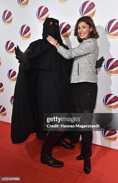 Actress Funda Vanroy poses with Jack the Ripper during the 'Jack the Ripper - Eine Frau jagt einen Moerder' Premiere at Gloria Palast on November 10,...