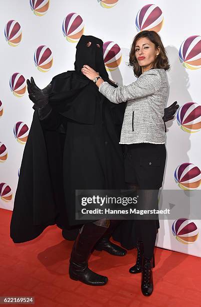 Actress Funda Vanroy poses with Jack the Ripper during the 'Jack the Ripper - Eine Frau jagt einen Moerder' Premiere at Gloria Palast on November 10,...