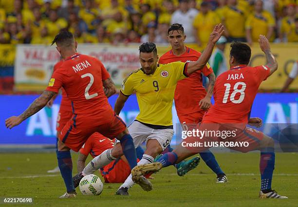 Colombia's Radamel Falcao is marked by Chile's Eugenio Mena and Gonzalo Jara during their 2018 FIFA World Cup qualifier football match in...
