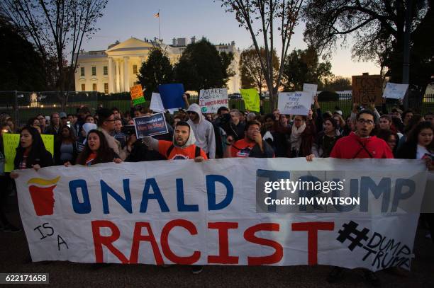 Anti President-elect Donald Trump protesters chant outside the White House in Washington, DC, November 10, 2016. Protesters burned a giant...