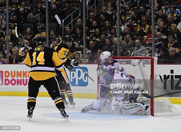 Tyler Pitlick of the Edmonton Oilers crashes into his goaltender Cam Talbot after Evgeni Malkin of the Pittsburgh Penguins scores a goal at PPG...