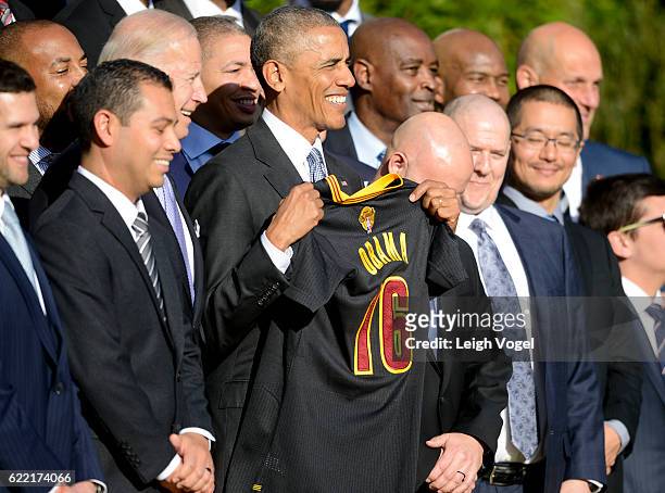 President Obama is presented with a jersey after welcoming the 2016 NBA Champions Cleveland Cavaliers to The White House on November 10, 2016 in...